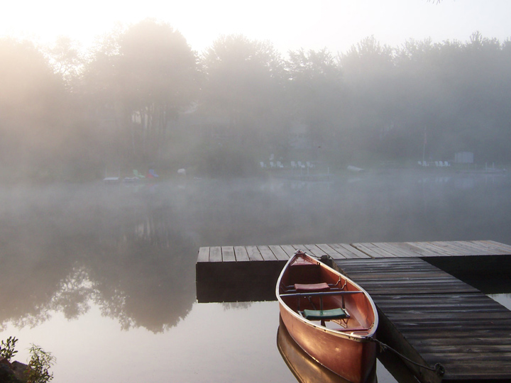 Canoe on a misty lake