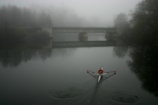 Early morning rower in fog